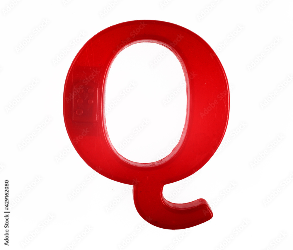 Plastic letter Q of the English alphabet against white background, top view. Plastic letter Q of the English alphabet against white background, top view.
