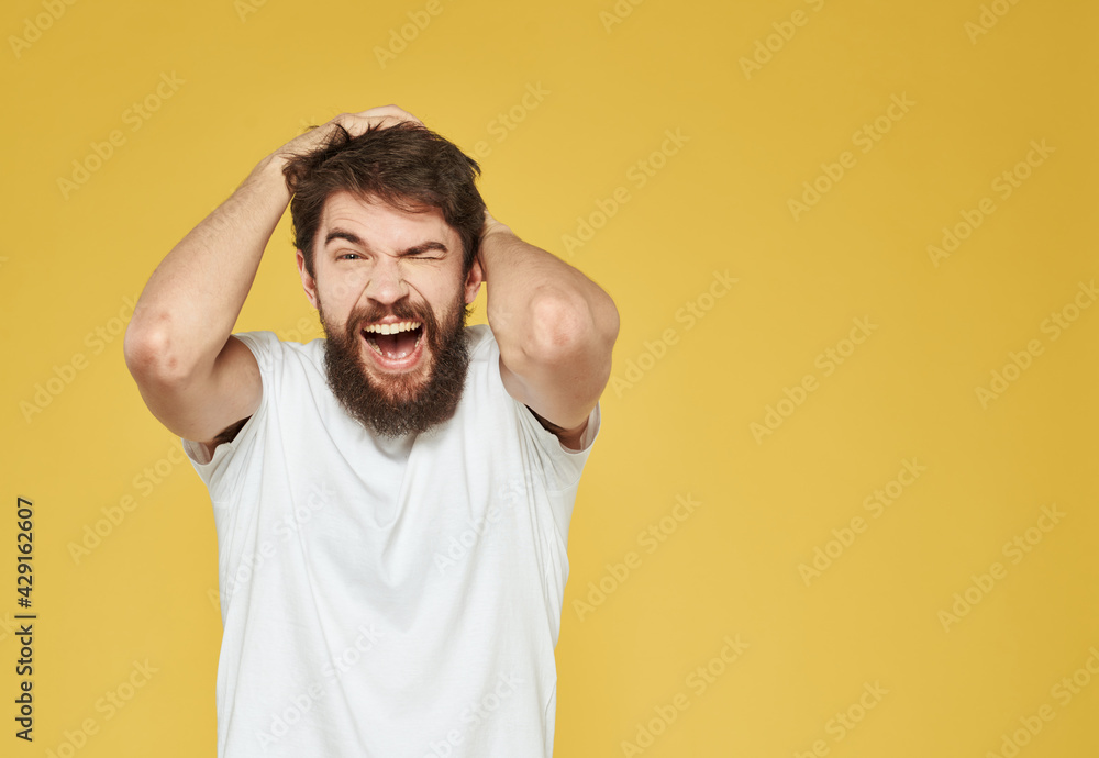 Portrait of a man on a yellow background gesturing with his hands emotions yellow background Copy Space Portrait of a man on a yellow background gesturing with his hands emotions yellow background Copy Space