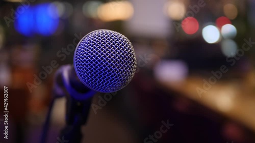 Concert microphone on the stage on blurred lights close up