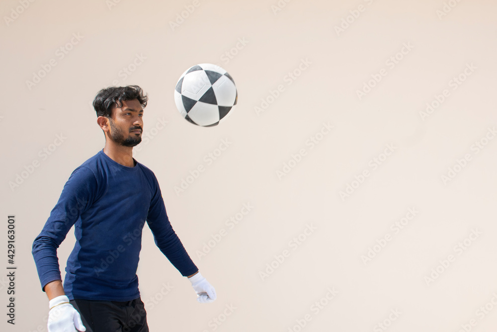 Indian Footballer Playing a football Indian Footballer Playing a football
