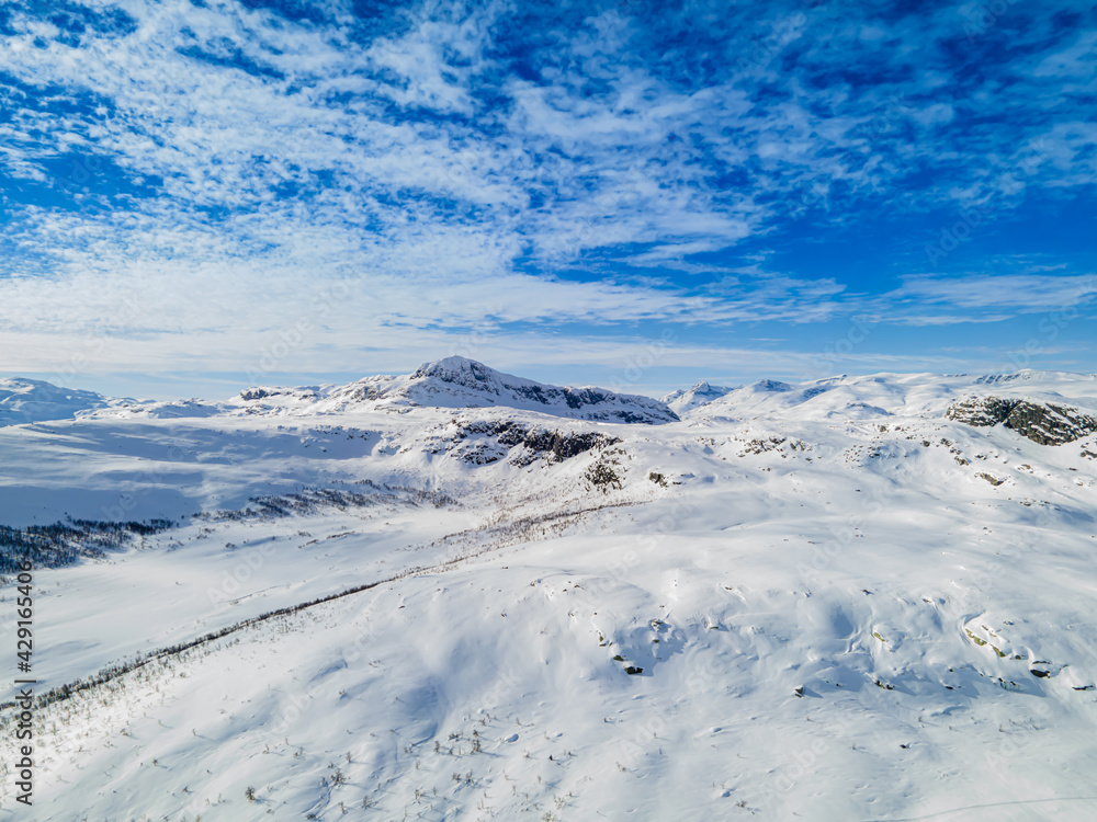 Stunning panoramic view over snow capped arctic mountains and wilderness terrain on a clear cold winters day.