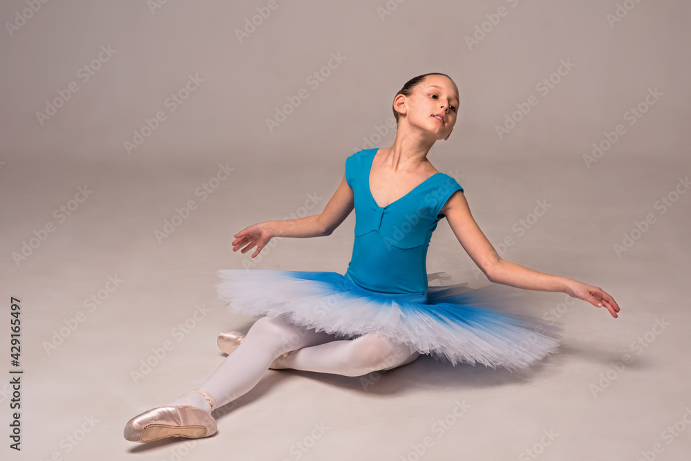 Ballerina in a ballet tutu and pointe shoes. The child ballerina is dancing. Girl on isolate