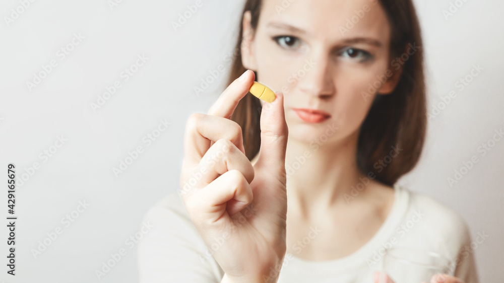 сaucasian woman holding in pill Close up . Sick female taking medicines, vitamin, antidepressant, painkiller or antibiotic.medicine, health care and Diet nutrition concept. Shallow depth of field сaucasian woman holding in pill Close up . Sick female taking medicines, vitamin, antidepressant, painkiller or antibiotic.medicine, health care and Diet nutrition concept. Shallow depth of field