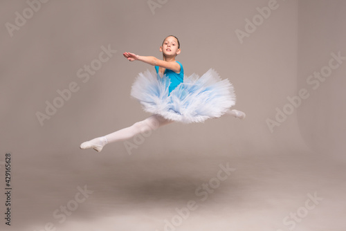 Ballerina in a ballet tutu and pointe shoes. The child ballerina is dancing. Girl on isolate © Hanna