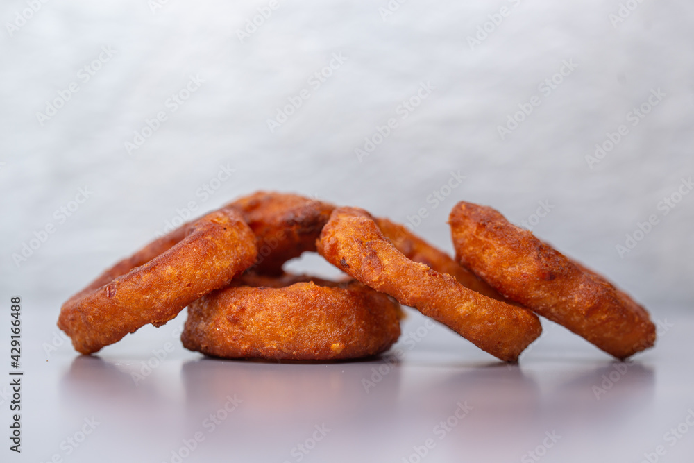 onion rings to beer on a gray background