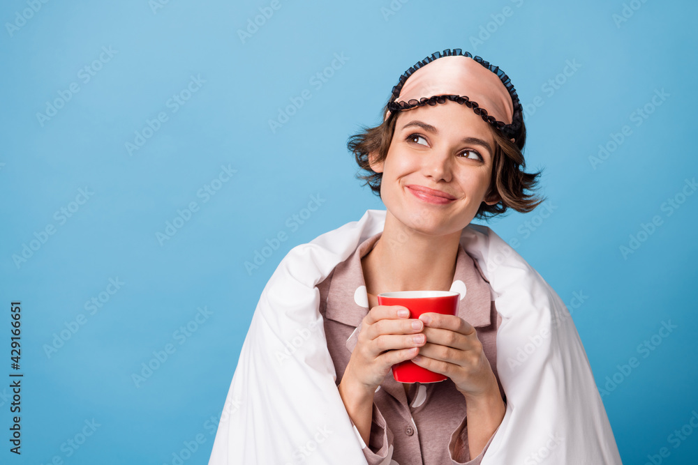 Photo of young girl happy smile enjoy morning cup of coffee dream look empty space cover duvet isolated over blue color background Photo of young girl happy smile enjoy morning cup of coffee dream look empty space cover duvet isolated over blue color background
