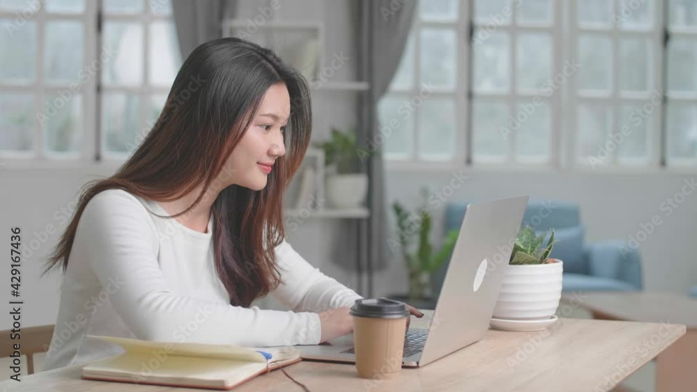 Happy Asian Girl Using Laptop Computer And Writing On Notebook At Home
Happy Asian Girl Using Laptop Computer And Writing On Notebook At Home