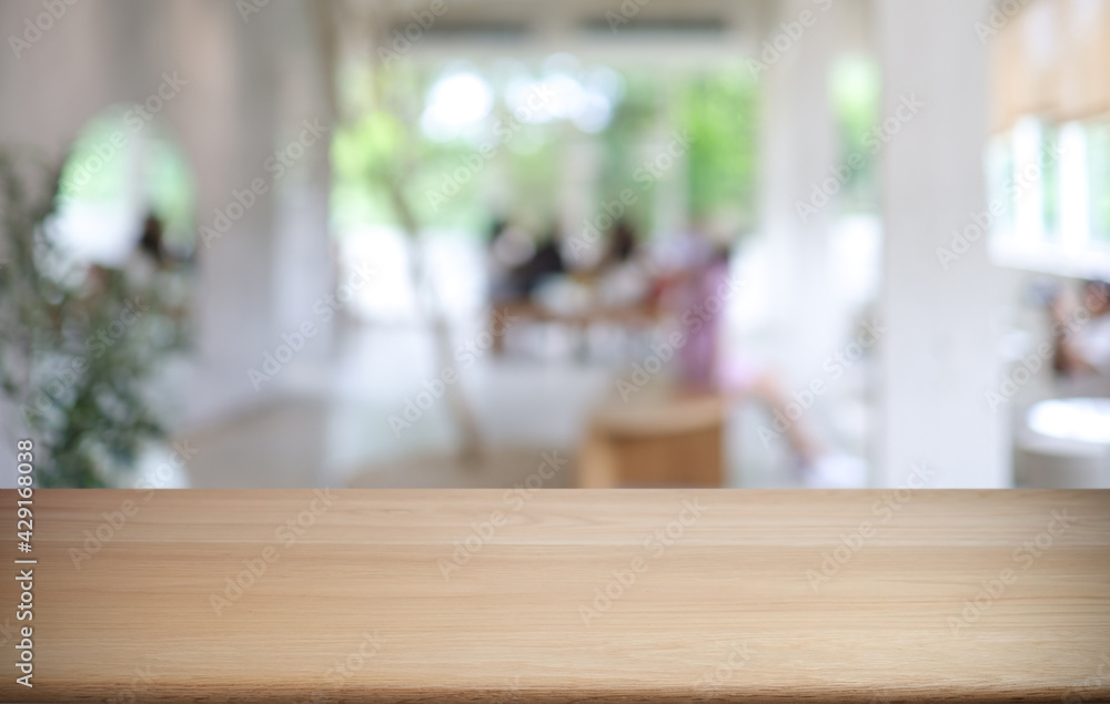 Empty wooden table in front of abstract blurred background of coffee shop . can be used for display or montage your products.Mock up for display of product Empty wooden table in front of abstract blurred background of coffee shop . can be used for display or montage your products.Mock up for display of product