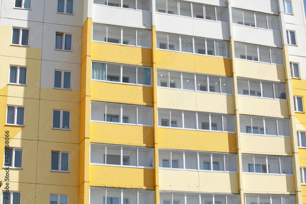 Facade of a New Residential Building in Yellow and White Colors On a Sunny Day. Concept New Building, Housing, Sale, Purchase and Rent of Housing, Mortgage, Housing Reform. Image for the Article