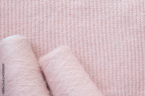 Background texture of pink pattern knitted fabric made of angora or wool.