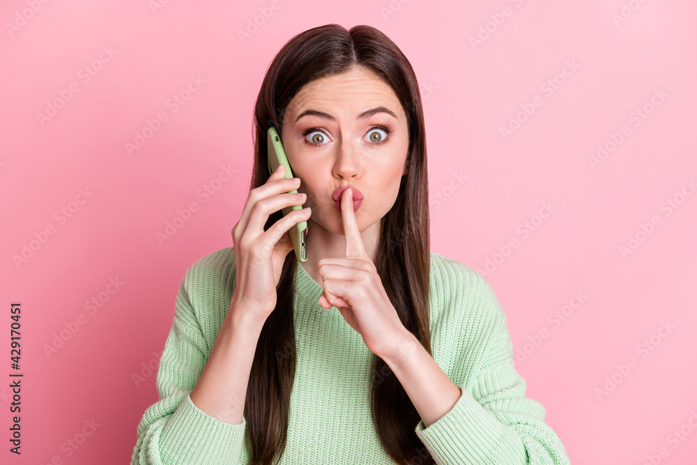 Photo of charming person finger covering mouth lips do not tell wear sweater isolated on pink color background Photo of charming person finger covering mouth lips do not tell wear sweater isolated on pink color background