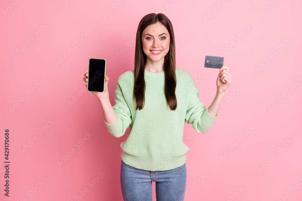 Photo of optimistic nice brunette girl show card telephone wear lime shirt jeans isolated on pink color background Photo of optimistic nice brunette girl show card telephone wear lime shirt jeans isolated on pink color background