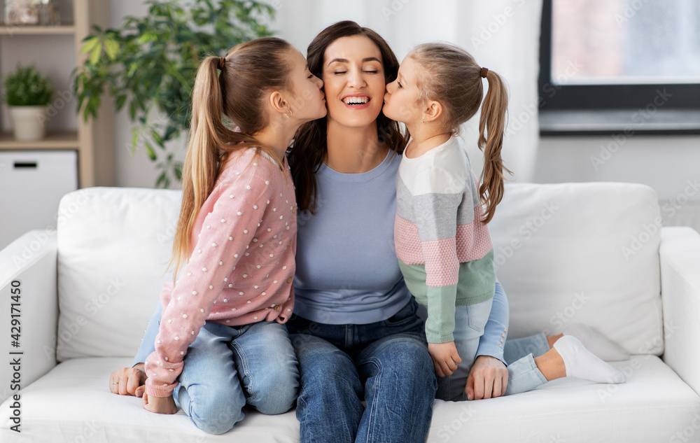 people, family and love concept - two daughters kissing happy mother at home people, family and love concept - two daughters kissing happy mother at home