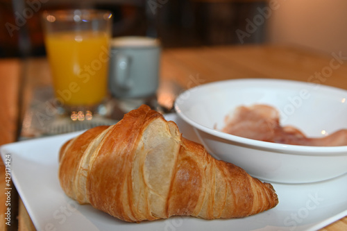 delicious freshly baked croissant. continental breakfast with croissant, coffee, juice and ham. delicious breakfast.