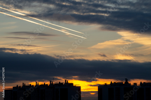 airplane tracks on the sky clouds sunset orange