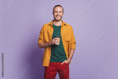 Close up portrait of cheerful guy hold cup drink coffee