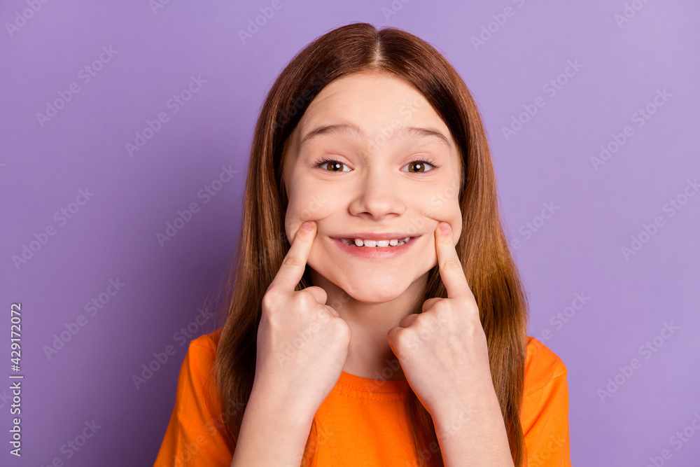 Close-up portrait of attractive cheerful glad girl touching sincere smile isolated over violet purple color background Close-up portrait of attractive cheerful glad girl touching sincere smile isolated over violet purple color background