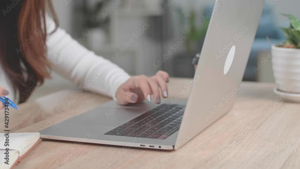 Close Up Girl Typing On Laptop Keyboard And Writing On Notebook Close Up Girl Typing On Laptop Keyboard And Writing On Notebook