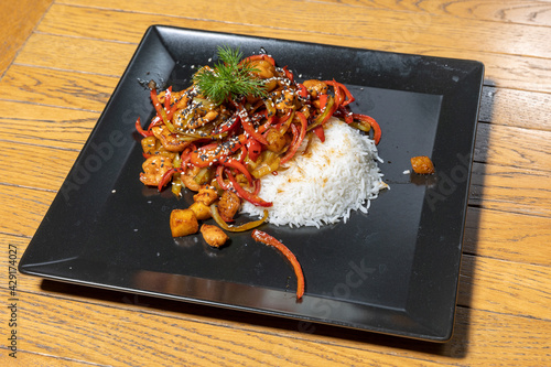 Szechuan chicken served with rice photo