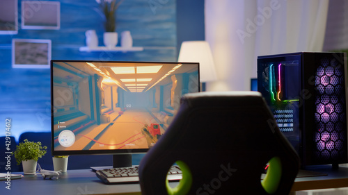 Fotografie RGB powerful personal computer gamer rig with first-person shooter game on screen