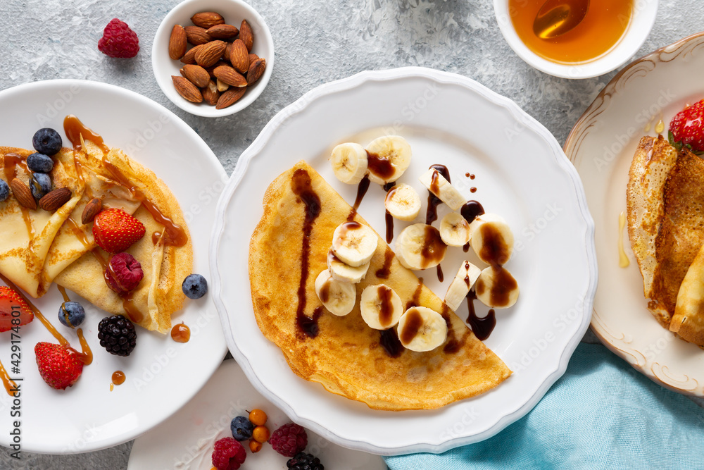 Overhead view of breakfast crepes with banana and berries Overhead view of breakfast crepes with banana and berries