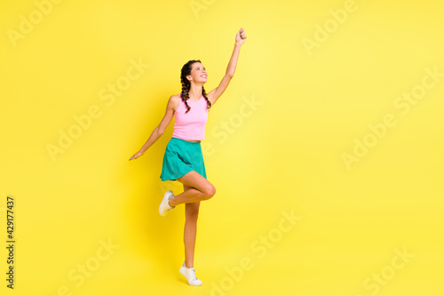 Full body photo of pretty happy lady hold look umbrella empty space good mood isolated on yellow color background