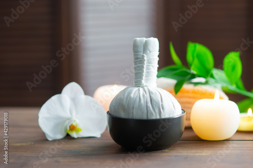 Spa background. Towel, candles, orchid flowers and herbal balls. Massage, oriental therapy, wellbeing and meditation.