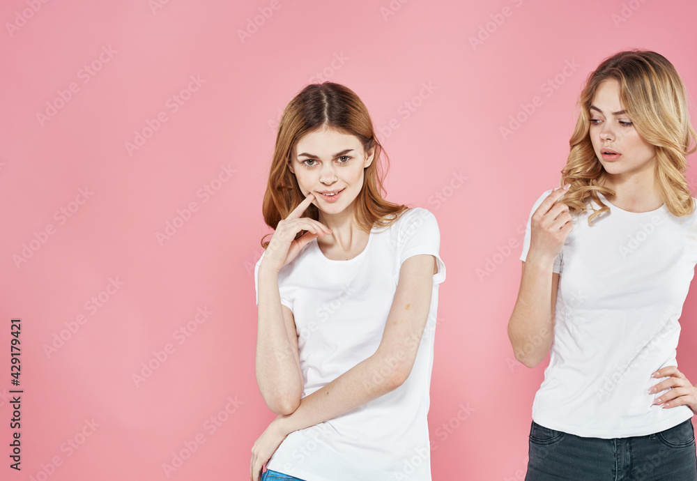 For woman in white t-shirts cropped view of girlfriend pink background For woman in white t-shirts cropped view of girlfriend pink background