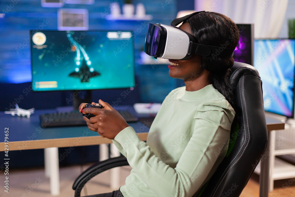 Professional esport player with vr headset using wireless joystick. Virtual space shooter game championship in cyberspace, esports player performing on pc during gaming tournament. Professional esport player with vr headset using wireless joystick. Virtual space shooter game championship in cyberspace, esports player performing on pc during gaming tournament.