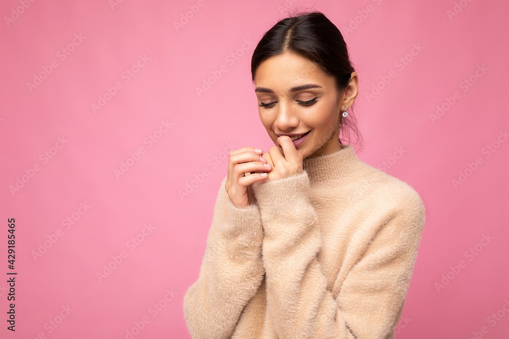 Portrait of young positive smiling tender winsome happy beautiful brunette woman with sincere emotions wearing casual beige jersey isolated over pink background with free space Portrait of young positive smiling tender winsome happy beautiful brunette woman with sincere emotions wearing casual beige jersey isolated over pink background with free space