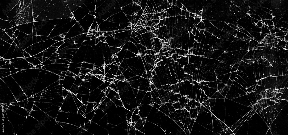 Shattered glass in dark background. Cracks on the glass. Panorama Shattered glass in dark background. Cracks on the glass. Panorama