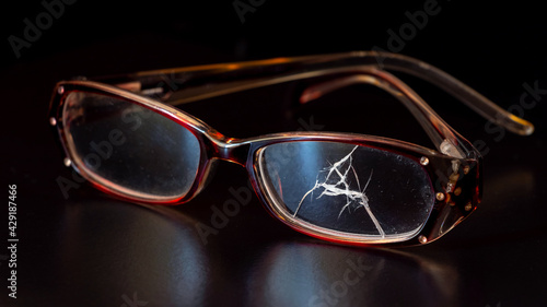 Broken glasses on a black background with reflection