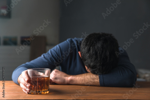 sad man hand alcohol of glass