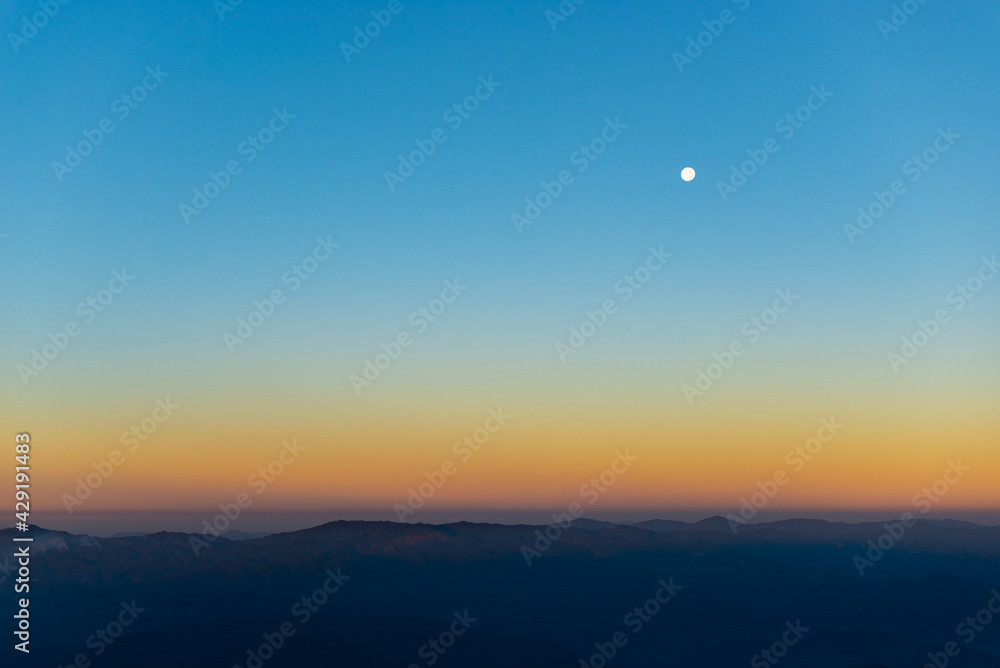 the moon over mountain in morning