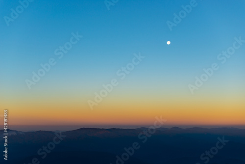 the moon over mountain in morning