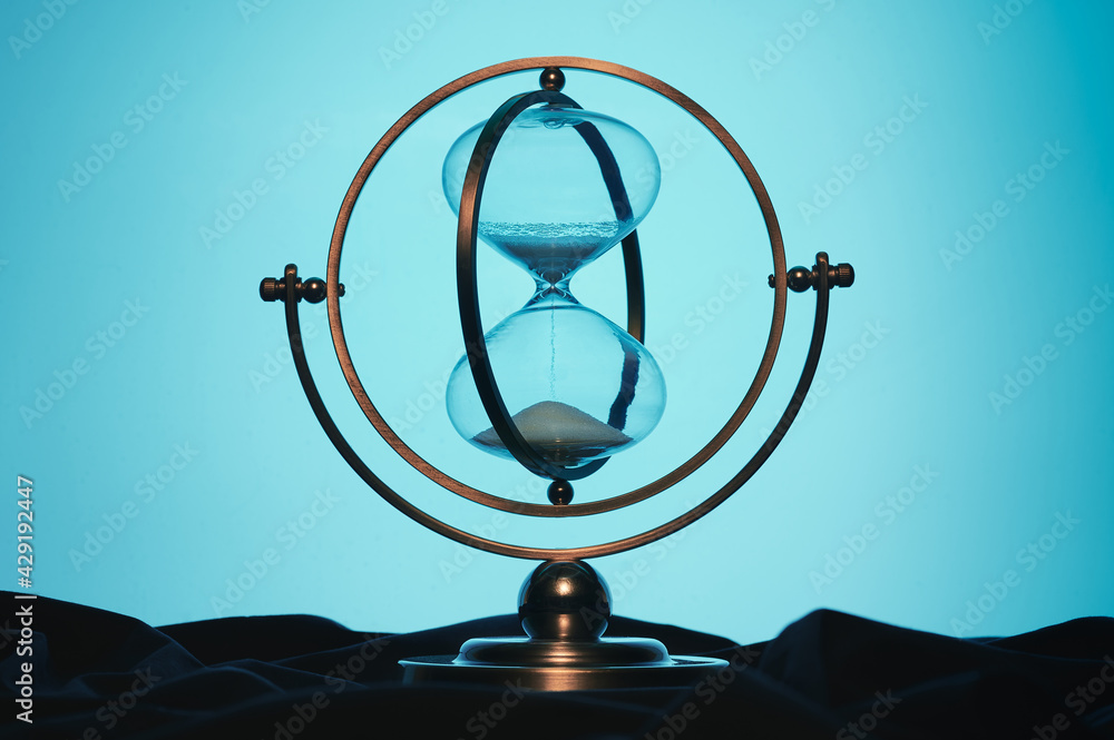 retro hourglass on a bluish background retro hourglass on a bluish background