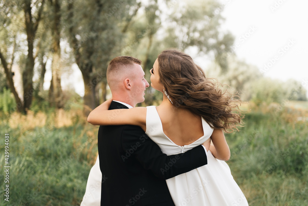 Fototapeta premium Wedding photo day. The bride and groom hold hands