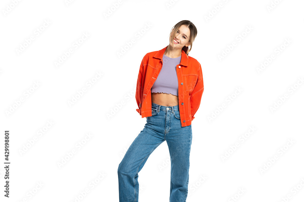happy young woman in jeans, crop top and orange shirt isolated on white happy young woman in jeans, crop top and orange shirt isolated on white