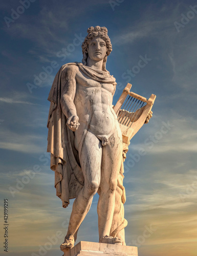 Apollo the ancient god of arts under impressive sky, Athens Greece