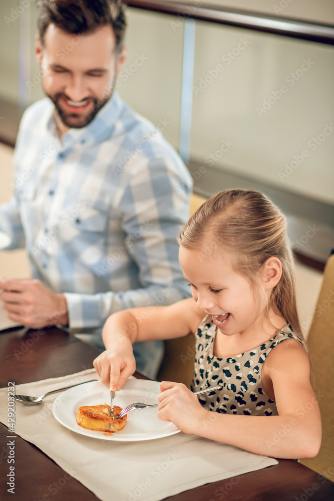 Young father having a breakfast with his daughter Young father having a breakfast with his daughter