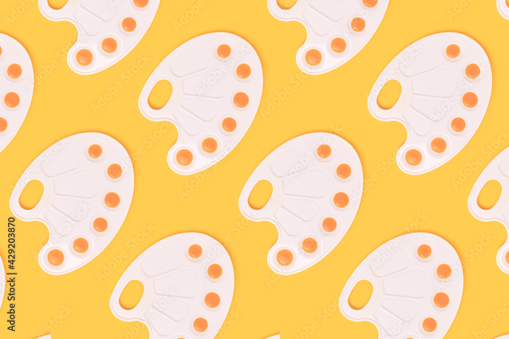 Repetitive pattern made of watercolor palettes on a yellow background. Artistic creative concept. Repetitive pattern made of watercolor palettes on a yellow background. Artistic creative concept.