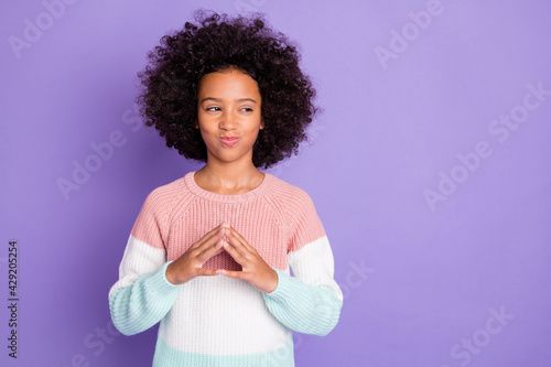 Portrait of cunning nice girl hands together look empty space wear pink sweater isolated on violet color background