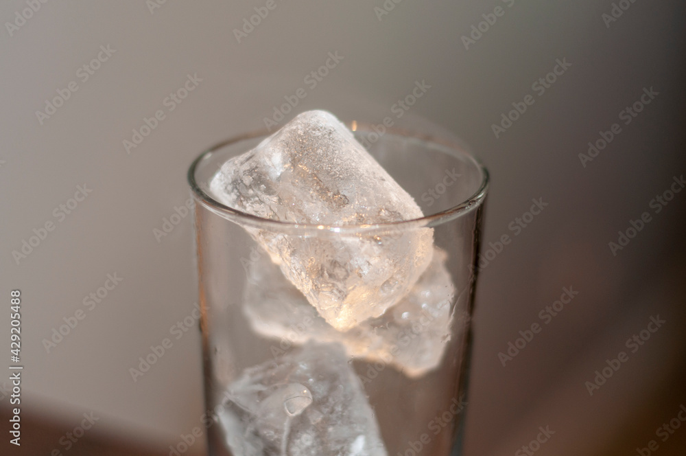 Ice cubes in a glass, close-up. Selective focus. Ice cubes in a glass, close-up. Selective focus.