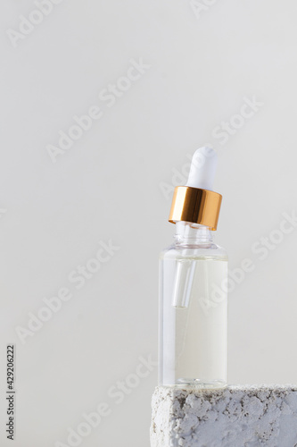Serum or oil for facial skin care. Cosmetic care product in a glass shade on a light background. Copy space. layout