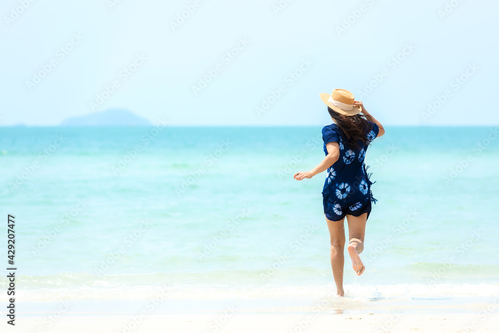 Summer vacations. Lifestyle woman relax and chill on beach background.  Asia happy young people running on the wave sea, summer trips walking enjoy  tropical beach