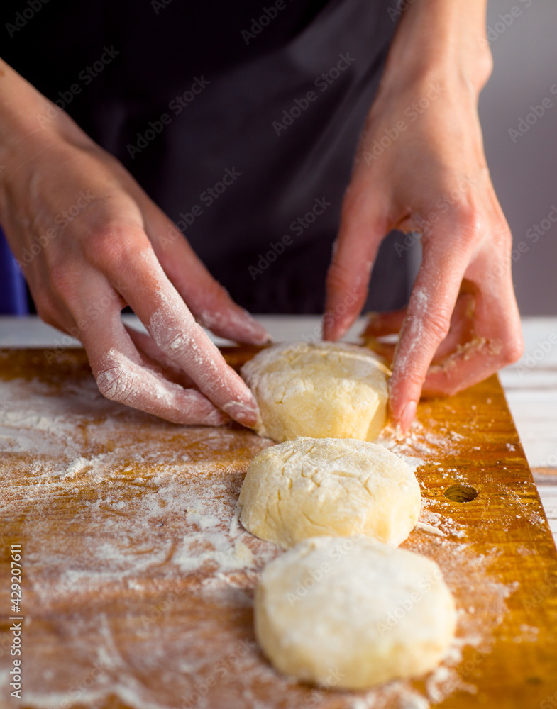cheesecake and with beautiful delicate women's hands, cottage cheese pancakes with flour cheesecake and with beautiful delicate women's hands, cottage cheese pancakes with flour