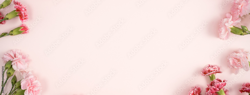 Design concept of Mother's day holiday greeting with carnation bouquet on pink table background Design concept of Mother's day holiday greeting with carnation bouquet on pink table background