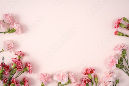 Design concept of Mother's day holiday greeting with carnation bouquet on pink table background