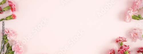 Design concept of Mother's day holiday greeting with carnation bouquet on pink table background