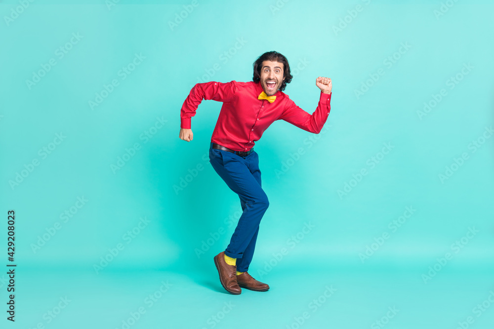 Full size photo of happy attractive funky gentleman dance good mood isolated on teal color background Full size photo of happy attractive funky gentleman dance good mood isolated on teal color background